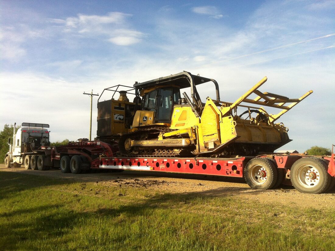 Crawler dozer chained down on a lowboy trailer