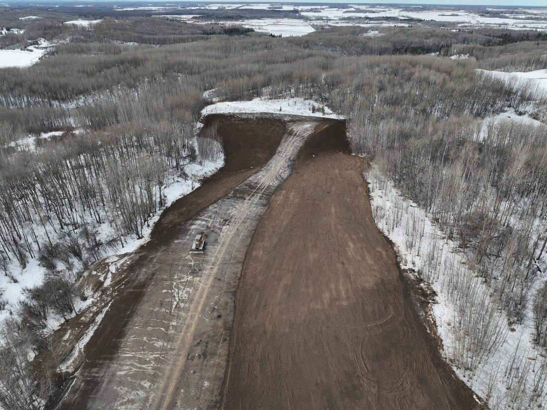 Aerial view of a right-of-way cut through winter terrain