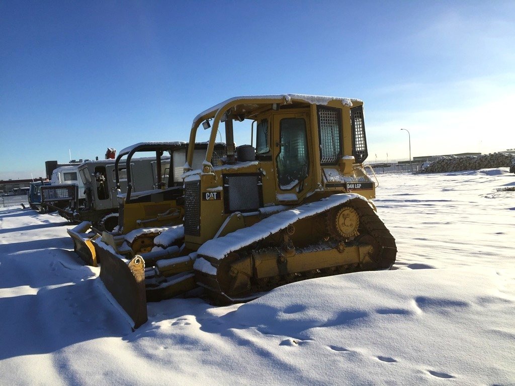 Caterpillar D4H LGP dozer, full machine, snow-covered yard — the kind of older iron Eddie can automate without touching its electronics